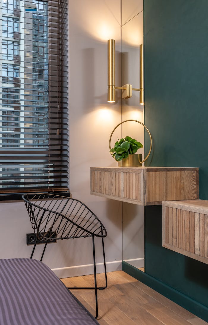 Stylish modern interior featuring a chair, lamp, and green accents.